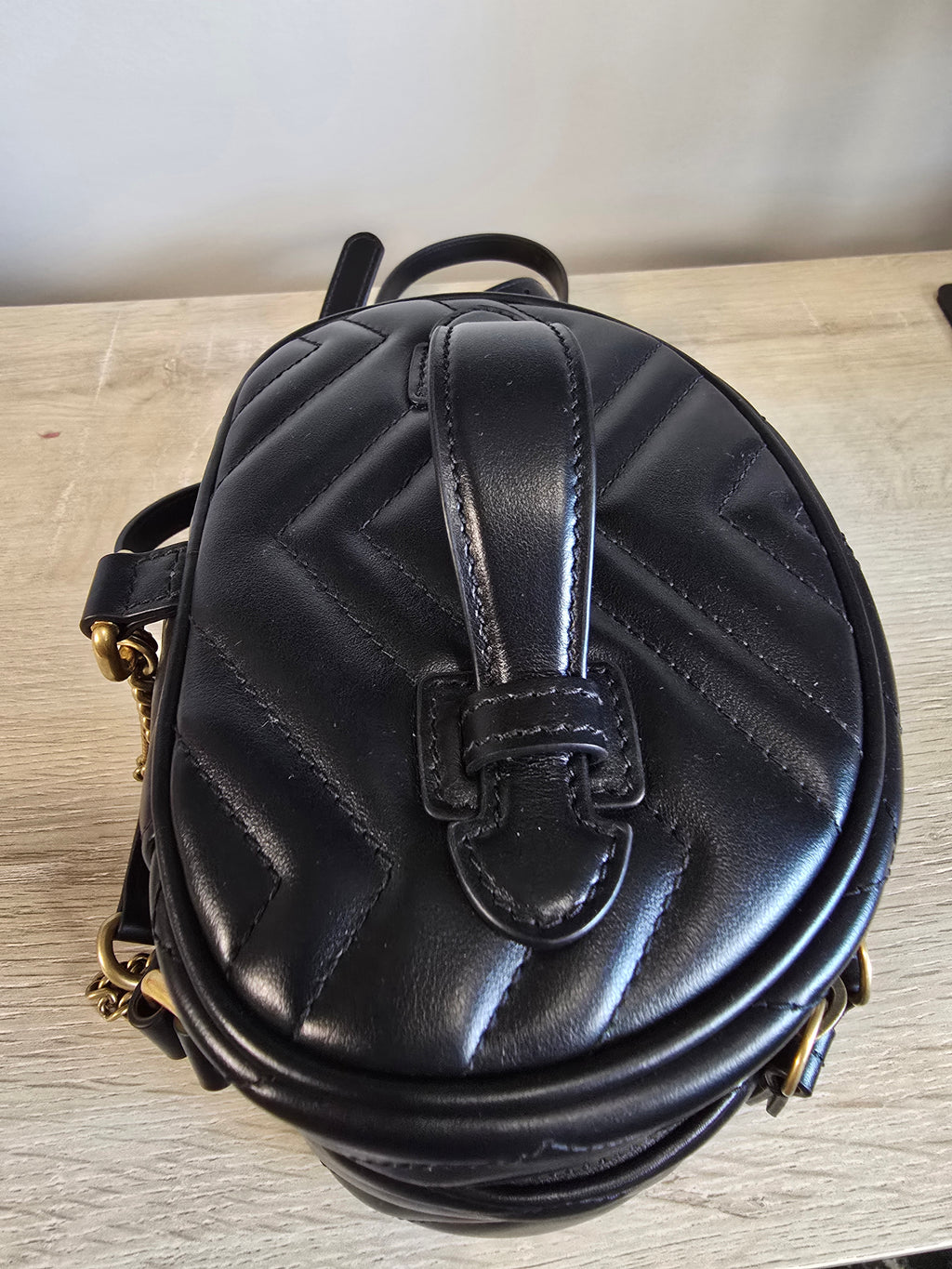 Gucci GG Marmont Mini Round Backpack Black Matelassé Leather Gold Hardware